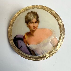 Vintage lipstick holder with a beautiful portrait of a lady. Includes a mirror.